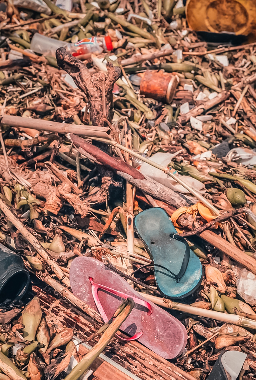 alt=“flip flops and litter on the beach clean up”