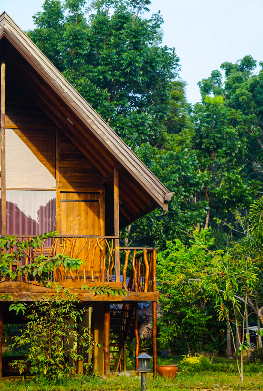 alt=“Kandy cabana with wooden hut with trees in the background”