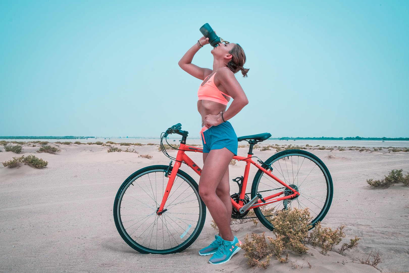 woman-on-bike-drinking-water